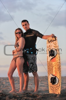 surf couple posing at beach on sunset