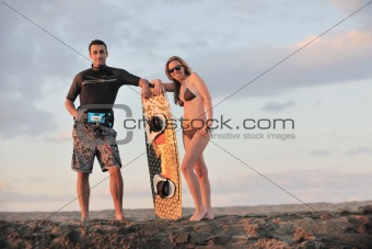 surf couple posing at beach on sunset