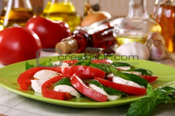 Salad caprese with fresh tomatoes, cheese and basil. 