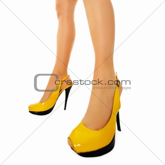 Female legs in yellow high heels