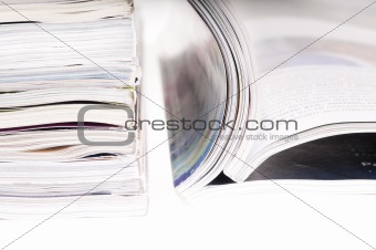 pile of magazines with bending pages