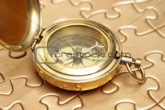 Golden Compass and Puzzle Concept