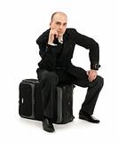 businessman sitting on his luggage