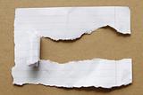 Ripped paper on brown background