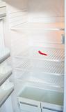 Empty fridge with chili pepper
