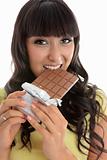 Beautiful girl eating decadent chocolate bar