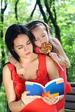  Little girl and mother reading the book. 