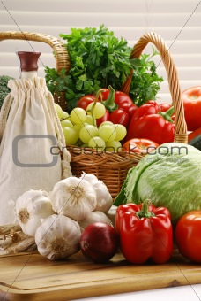 Composition with raw vegetables and wicker basket
