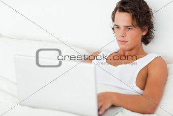 Cute man using a laptop