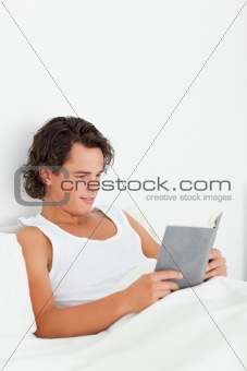 Portrait of a cute man reading a book