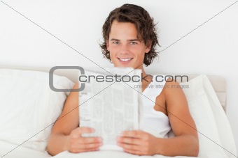 Young man holding a newspaper
