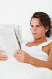 Portrait of a young man reading a newspaper