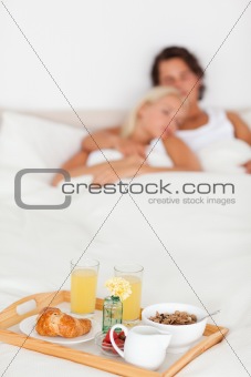 Breakfast on a tray with a couple sleeping