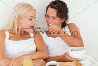 Happy couple eating breakfast