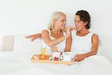 Woman giving a piece of croissant to her boyfriend
