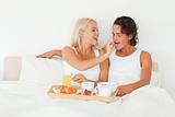 Woman giving a piece of croissant to her fiance