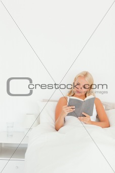 Portrait of a cute woman reading a book