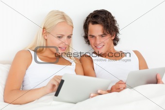 Gorgeous couple using tablet computers