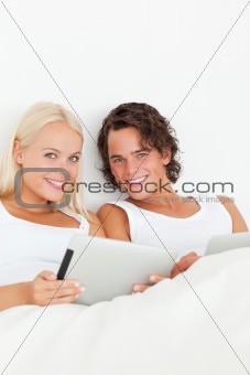 Portrait of a happy couple using tablet computers