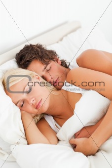 Couple hugging while sleeping