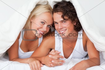 Cute couple under a duvet