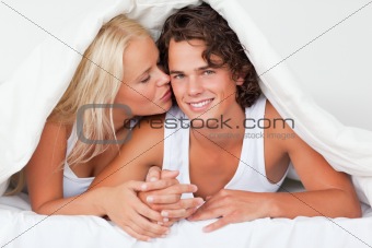 Woman kissing her boyfriend on the cheek