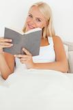 Portrait of a smiling woman holding a book