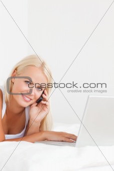 Portrait of a woman on the phone with a notebook