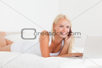 Smiling woman on the phone with a notebook
