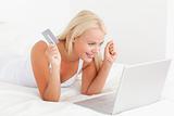 Cheerful woman purchasing online