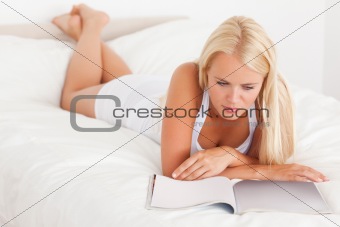 Cute woman reading magazine