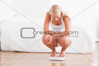 Fit woman on a weighing machine