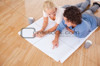 Man showing a point on a plan to his girlfriend