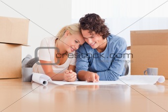 Happy couple organizing their new home