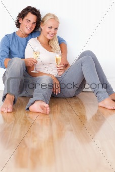 Portrait of a cute couple with glasses of sparkling wine
