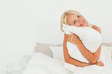 Lovely woman holding a pillow