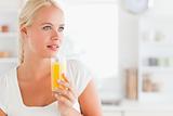 Close up of a woman drinking orange juice