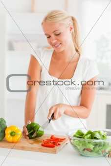Cute woman slicing pepper