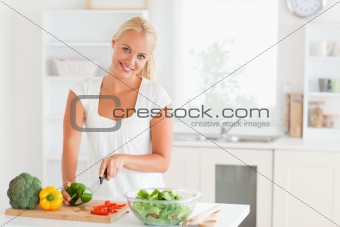Good looking woman slicing pepper