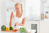 Blond-haired woman slicing pepper