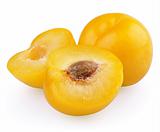 Yellow plum with halves isolated on white background