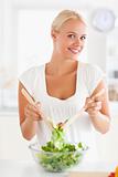 Woman mixing a salad