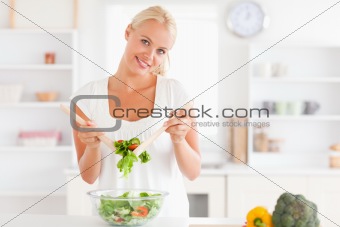 Cute woman mixing a salad