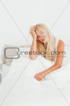 Portrait of a beautiful woman sitting on her bed
