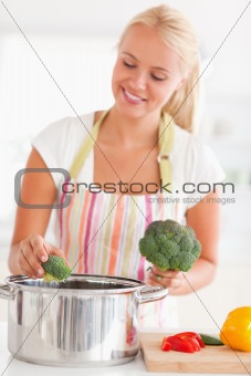 Portrait of a woman putting cabbage on water