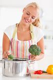 Portrait of a cute woman putting cabbage on water