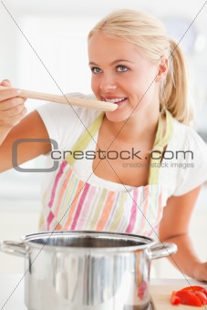 Portrait of a blonde woman tasting her meal