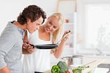 Couple cooking with a pan