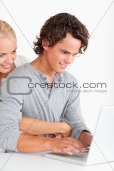 Portrait of a cute couple using a laptop
