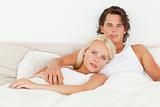 Serene couple lying on a bed